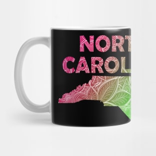 Colorful mandala art map of North Carolina with text in pink and green Mug